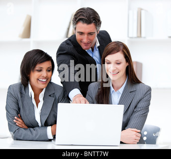 Multi-ethnic business team working at a computer Stock Photo