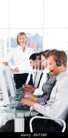 Female leader managing her team in a call center Stock Photo