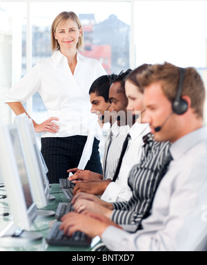 Female leader managing her working team in a call center Stock Photo