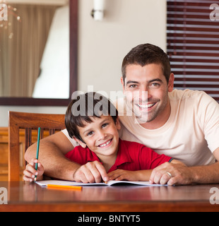 Smiling father helping his son for homework Stock Photo