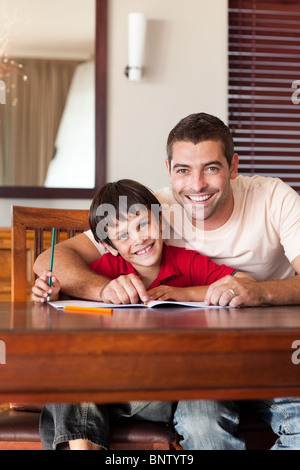 Radiant father helping his son for homework Stock Photo