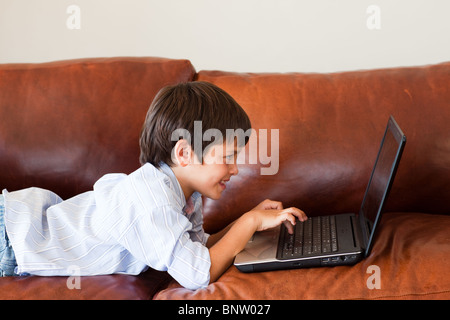 Kid using his laptop Stock Photo