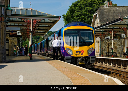 First train waiting at Grange over Sands railway station in summer Cumbria England UK United Kingdom GB Great Britain Stock Photo