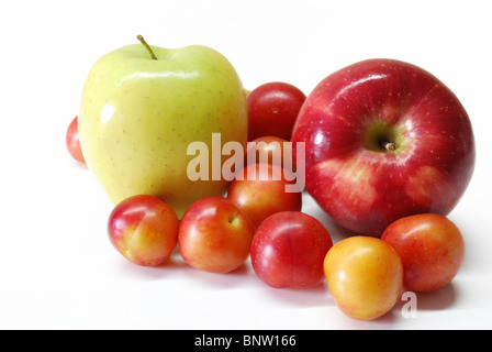 apples and cherry plums on white background Stock Photo