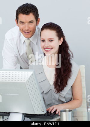Businessman and businesswoman using a computer Stock Photo