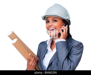 Smiling architect on phone wearing a hardhat Stock Photo