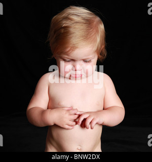 baby looking down pout Stock Photo