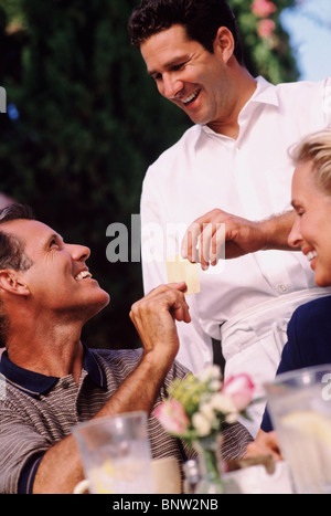 Man giving his credit card to waiter Stock Photo