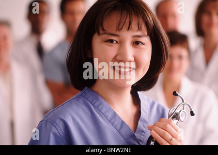 Portrait of a doctor with medical team in the background Stock Photo