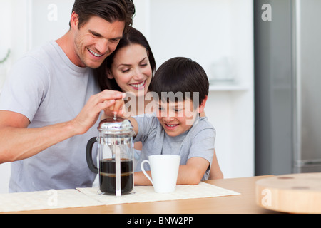 Smiling family preparing coffee Stock Photo