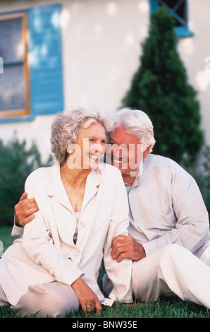 Senior couple relaxing on lawn together Stock Photo