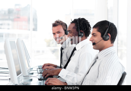 International business team in a call center wearing headsets Stock Photo