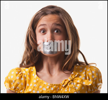 Teenage girl with duct tape on her mouth Stock Photo