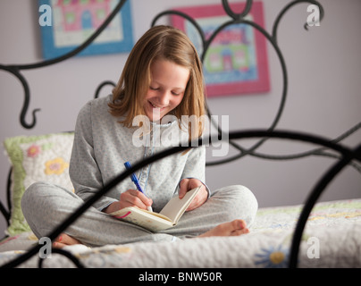 Young girl writing in her diary Stock Photo