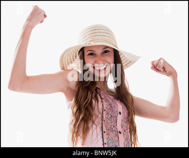 Smiling woman flexing her muscles Stock Photo