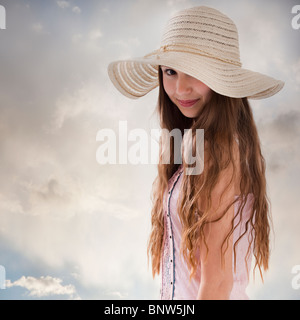 Beautiful long haired woman wearing a straw hat Stock Photo