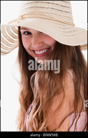 Smiling long haired woman wearing a straw hat Stock Photo
