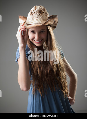 Beautiful long haired cowgirl tipping her hat Stock Photo