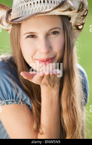 Beautiful cowgirl blowing a kiss Stock Photo