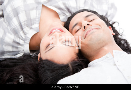 Smiling couple relaxing on the floor Stock Photo