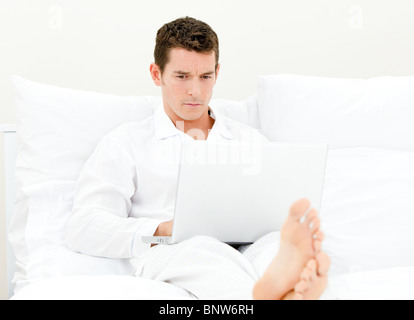 Handsome man sitting on the sofa Stock Photo
