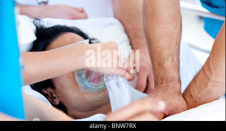 Medical team giving oxygen mask to the patient Stock Photo