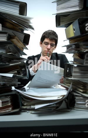 Overworked bookkeeper at his desk Stock Photo