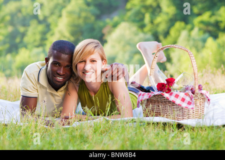 interracial couple picnicking Stock Photo