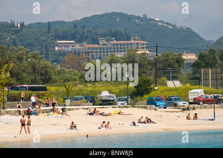 Corfu beach. Tourists relaxing on sandy beach at Paleokastritsa on the Greek island of Corfu Greece GR Stock Photo