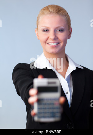 Business woman holding up a calculator Stock Photo