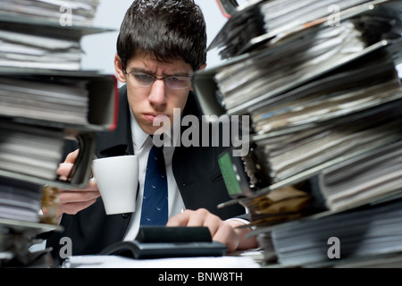 Accountant drinking coffee at work Stock Photo