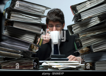 Accountant drinking coffee at work Stock Photo