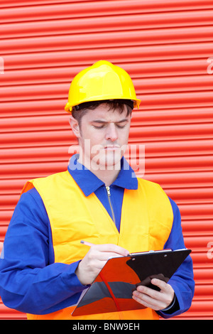 Handsome male engineer writing his report Stock Photo