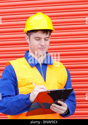Serious male engineer writing his report Stock Photo