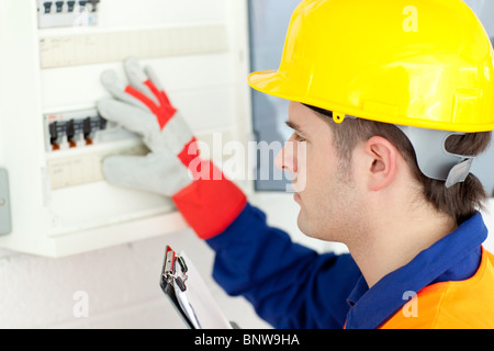 Electrician repairing a power plan Stock Photo