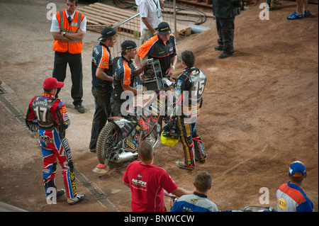 2010 British Speedway Grand Prix, Ben Barker (reserve) watches Woffinden preparing for his next race Stock Photo