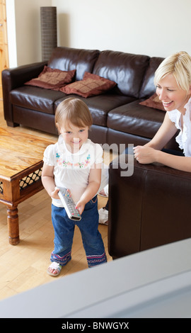Sweet girl standing in front of  the television Stock Photo