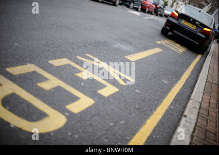 Parking restrictions outside a school are ignored by parents too lazy to drop off their children a safe distance away. Stock Photo