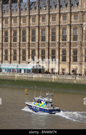 A Metropolitan Police motor launch on the River Thames at the Houses of Parliament, Westminster, London, England, U.K. Stock Photo