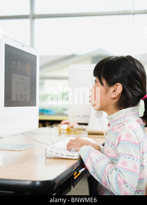 Student working on computer in classroom Stock Photo