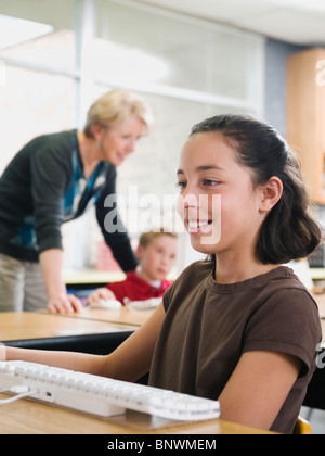 Students working on computers in classroom Stock Photo