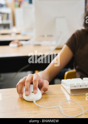 Students hand on computer mouse Stock Photo