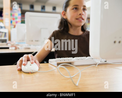 Student working on computer in classroom Stock Photo