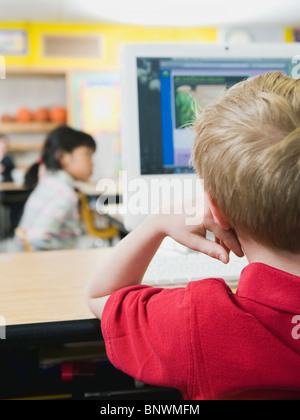 Elementary students working on computers Stock Photo