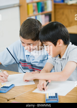 Students doing math work in classroom Stock Photo