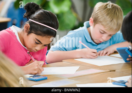 Students doing math work in classroom Stock Photo