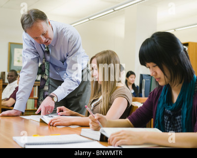 Professor giving instruction to college student Stock Photo