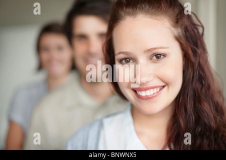 three people standing in a row Stock Photo