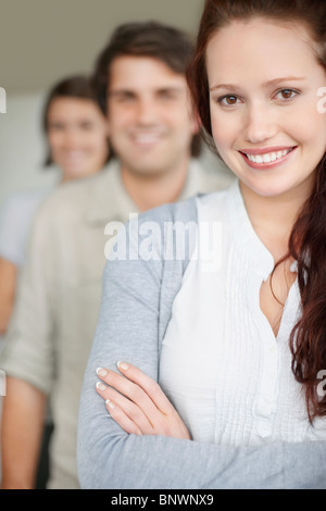 three people standing in a row Stock Photo