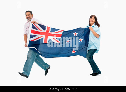 two people carry the New Zealand flag Stock Photo